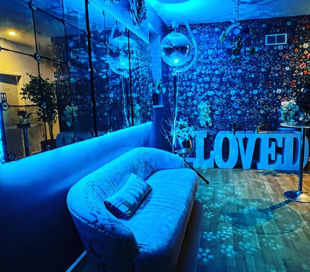Venue lounge with blue lighting, disco balls, mirrors, and marquee letters