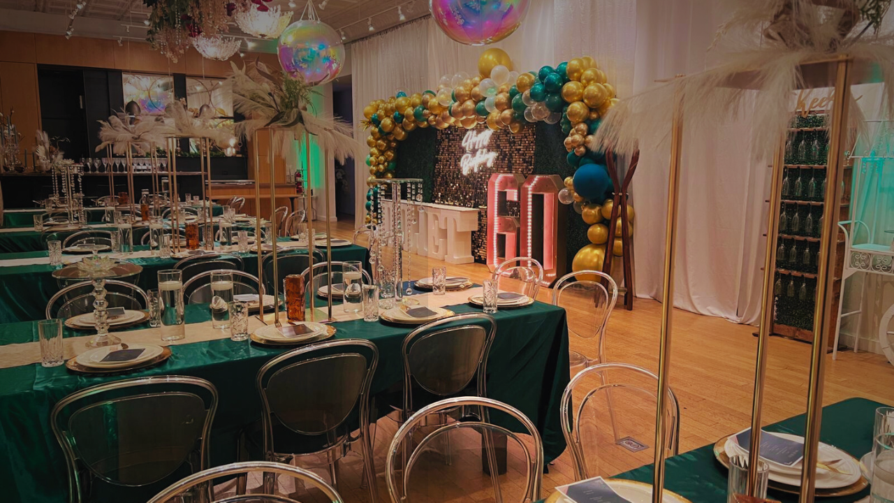 The Long Hall interior with exposed brick, banquet tables, and dramatic uplighting